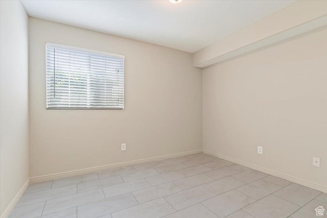 spare room featuring baseboards