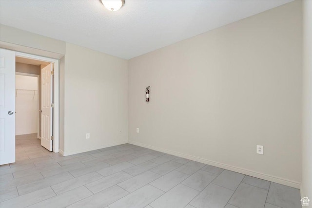 spare room with baseboards
