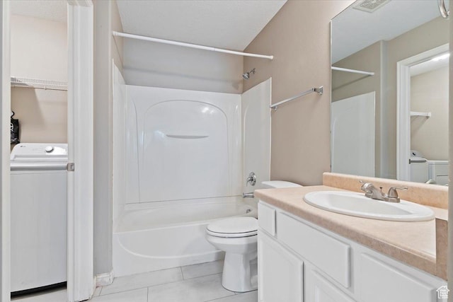 bathroom with toilet, tile patterned floors, vanity,  shower combination, and washer and dryer