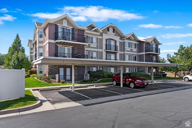 view of apartment building / complex with covered parking