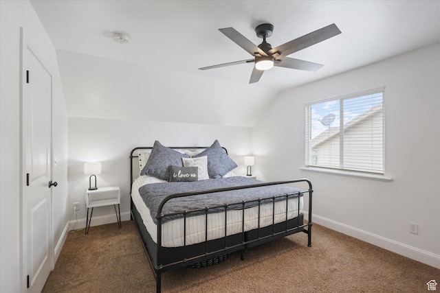 bedroom with carpet flooring, vaulted ceiling, baseboards, and a ceiling fan