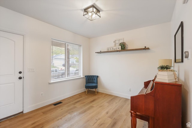 sitting room with light wood-style flooring and baseboards