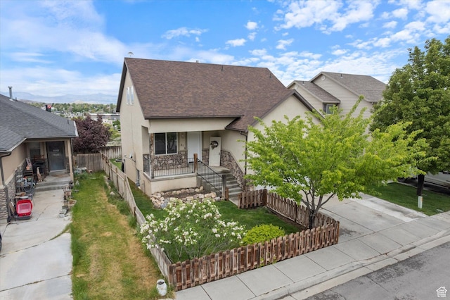 61 N Peach St, Santaquin, UT 84655 - view of front of property with stucco siding, roof with shingles, covered porch, driveway, and stone siding