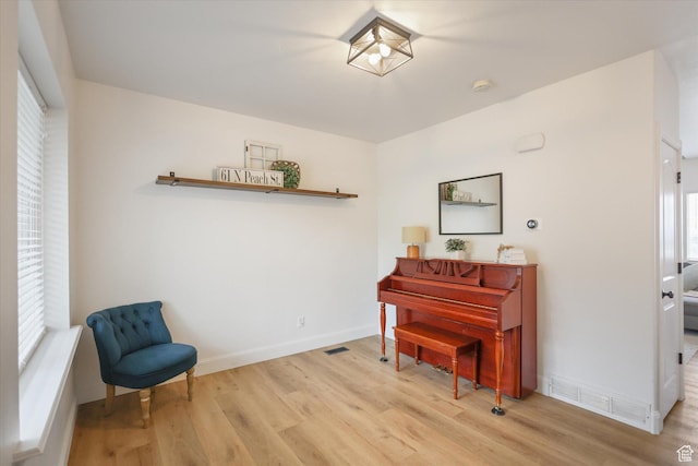 living area with wood finished floors and baseboards