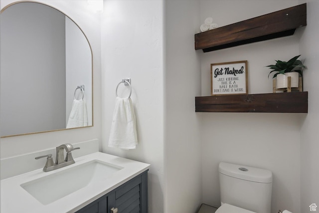 bathroom with toilet and vanity
