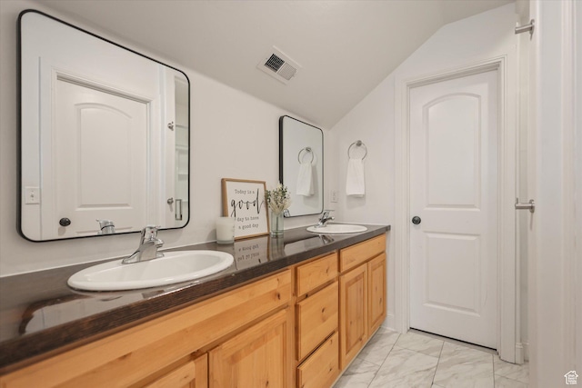 full bathroom featuring vaulted ceiling, marble look tiles, and double vanity