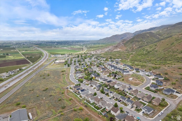 aerial overview of property's location with a mountain backdrop and nearby suburban area