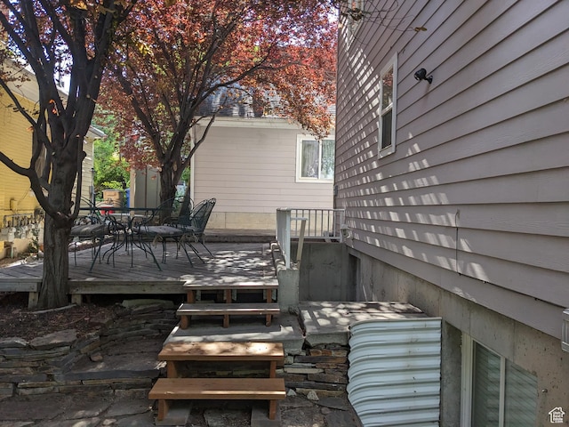 wooden terrace featuring outdoor dining area