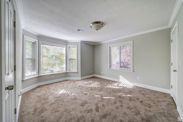 carpeted empty room with baseboards, ornamental molding, and a textured ceiling