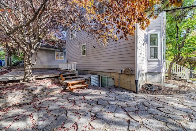 back of property with a deck and a patio area