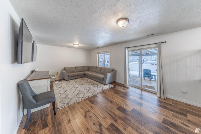 1501 W 2060 S, Woods Cross, UT 84087 - living area featuring wood finished floors, a textured ceiling, and baseboards