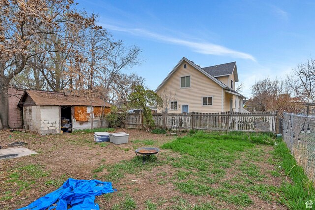 358 W 400 S, Provo, UT 84601 - fenced backyard featuring an outdoor fire pit, a storage unit, and an outdoor structure