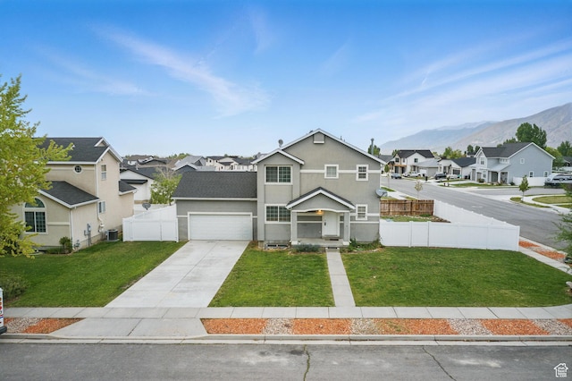 677 E 700 N, Tooele, UT 84074 - traditional home with a residential view, concrete driveway, a mountain view, a garage, and central AC unit