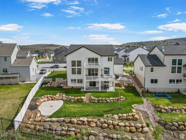 rear view of property featuring a residential view and a patio area