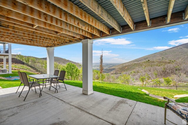 view of patio / terrace with outdoor dining area and a mountain view