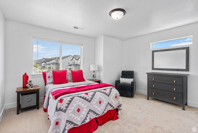 carpeted bedroom featuring baseboards