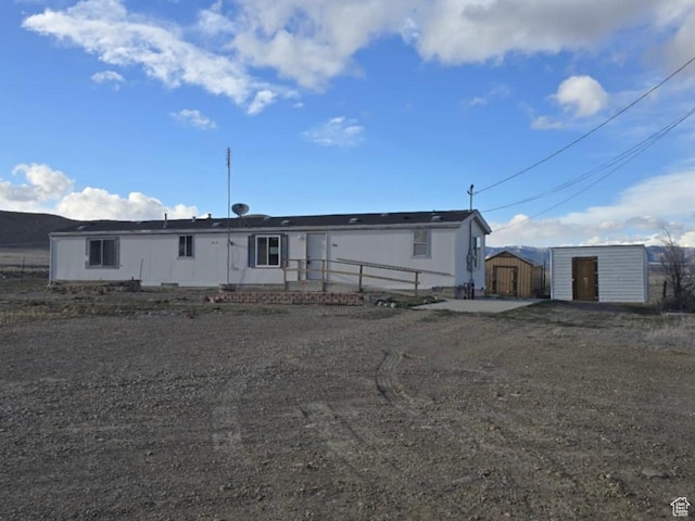 view of front of home with a shed and an outdoor structure