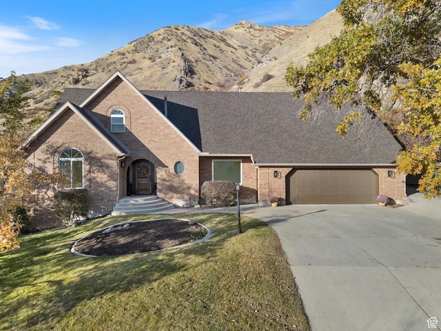 2078 E Spring Oaks Dr N, Springville, UT 84663 - view of front facade featuring brick siding, concrete driveway, a front yard, and a mountain view