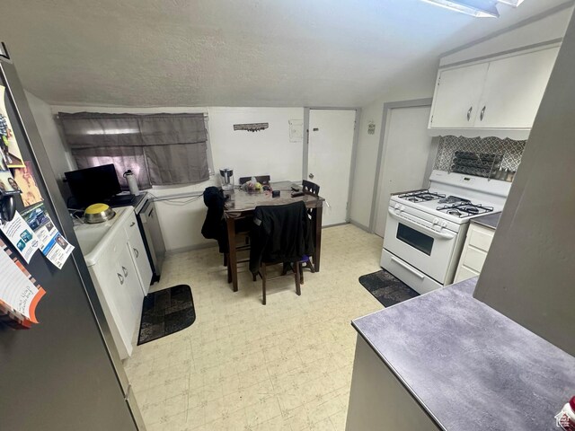 90 S 300 W, Payson, UT 84651 - kitchen with gas range gas stove, light floors, white cabinetry, an office area, and decorative backsplash