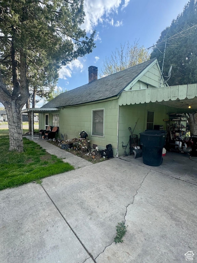 90 S 300 W, Payson, UT 84651 - view of home's exterior with a chimney, roof with shingles, concrete driveway, and a carport