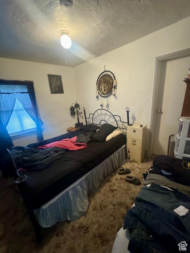 carpeted bedroom with a textured ceiling