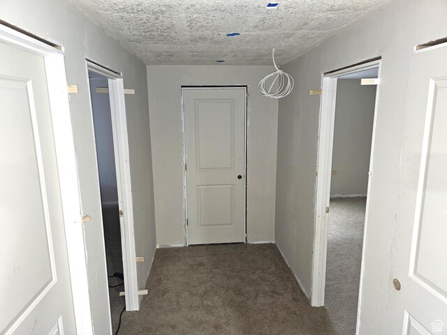 1771 E Skyline Dr Unit I4, Eagle Mountain, UT 84005 - hall featuring carpet flooring, a textured ceiling, and baseboards