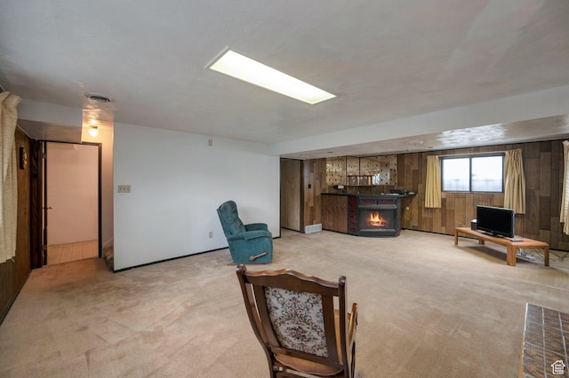 825 W Arapahoe Ave S, Salt Lake City, UT 84104 - living room with light carpet, a lit fireplace, and wooden walls