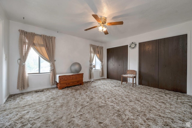 825 W Arapahoe Ave S, Salt Lake City, UT 84104 - carpeted bedroom with two closets and a ceiling fan