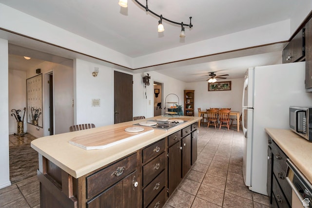 825 W Arapahoe Ave S, Salt Lake City, UT 84104 - kitchen with stainless steel microwave, electric cooktop, dishwasher, light countertops, and ceiling fan