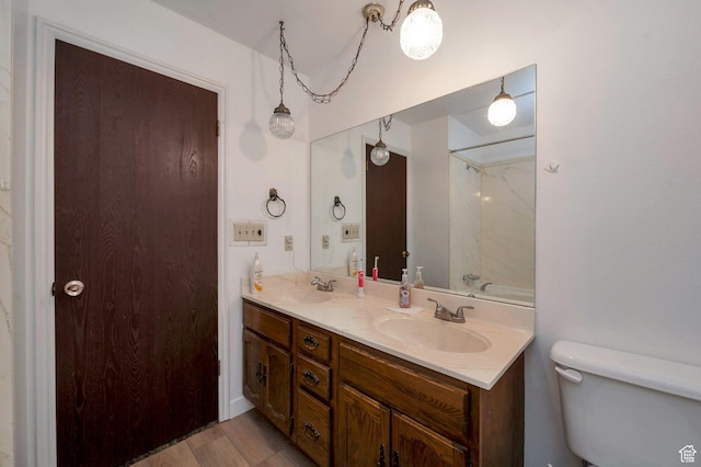 825 W Arapahoe Ave S, Salt Lake City, UT 84104 - bathroom with toilet, double vanity, and wood finished floors