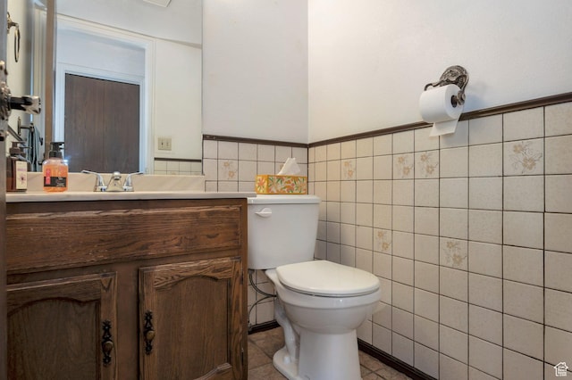 825 W Arapahoe Ave S, Salt Lake City, UT 84104 - bathroom with toilet, tile walls, vanity, and wainscoting