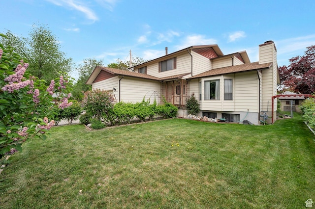825 W Arapahoe Ave S, Salt Lake City, UT 84104 - rear view of property featuring a chimney, a yard, and a garage