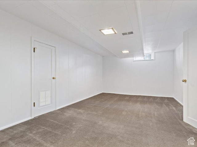 basement featuring carpet floors and baseboards