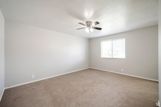 unfurnished room with ceiling fan, carpet floors, and baseboards