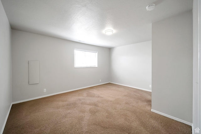 unfurnished room with carpet floors, a smoke detector, and baseboards