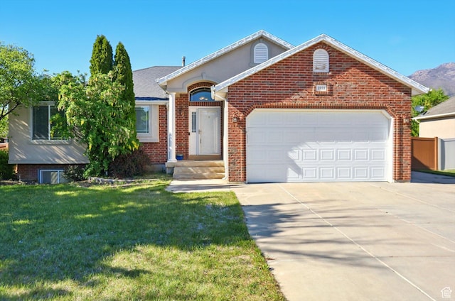 view of front of house featuring driveway, brick siding, an attached garage, and a front lawn
