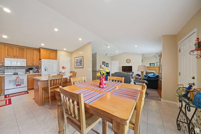 dining room featuring light tile patterned floors, vaulted ceiling, recessed lighting, and baseboards