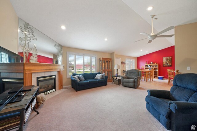 living room with vaulted ceiling, a tiled fireplace, a ceiling fan, carpet floors, and recessed lighting