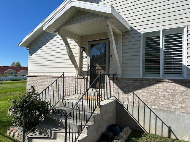 property entrance featuring brick siding