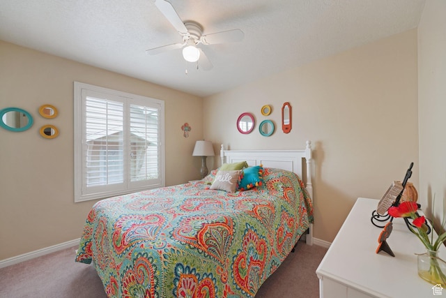 carpeted bedroom featuring baseboards and ceiling fan