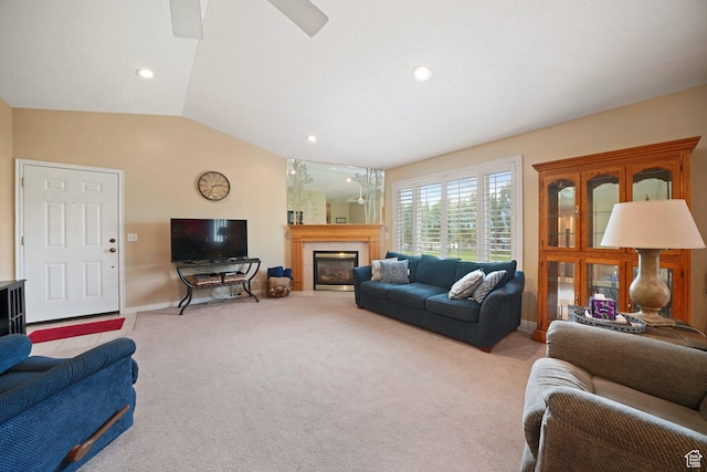 living area featuring carpet, baseboards, a tile fireplace, lofted ceiling, and recessed lighting