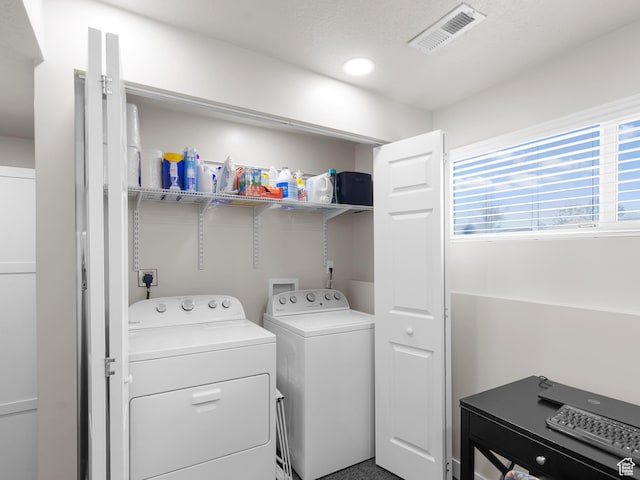 clothes washing area with washer and clothes dryer and recessed lighting