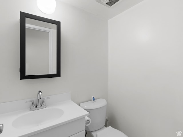 half bath featuring toilet and vanity