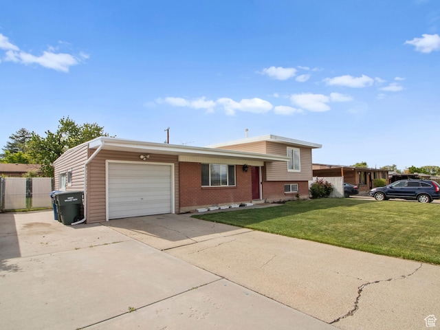 split level home with an attached garage, driveway, and brick siding