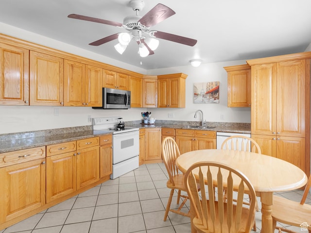 kitchen with white appliances, a sink, light tile patterned floors, and a ceiling fan