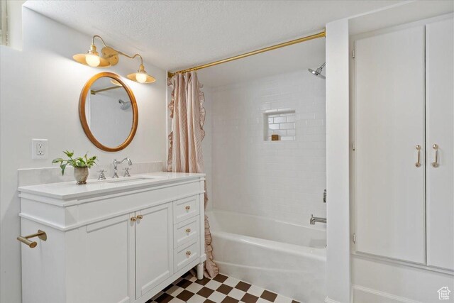 1920 E Westminster Ave, Salt Lake City, UT 84108 - full bath featuring tile patterned floors, a textured ceiling, shower / bath combo, and vanity
