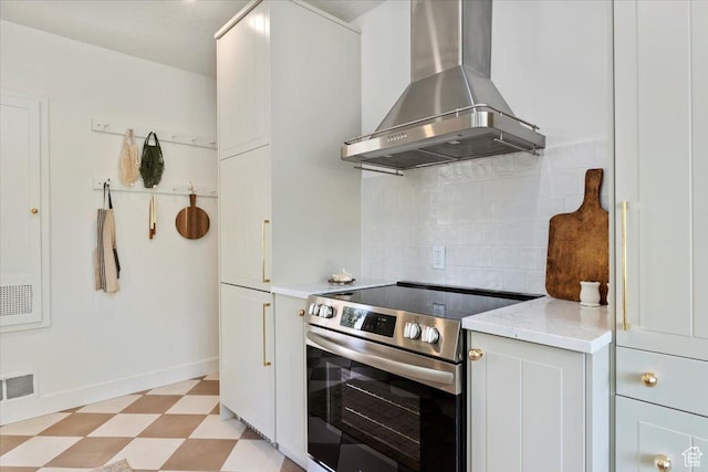 1920 E Westminster Ave, Salt Lake City, UT 84108 - kitchen with wall chimney exhaust hood, stainless steel electric range, light flooring, backsplash, and light stone countertops
