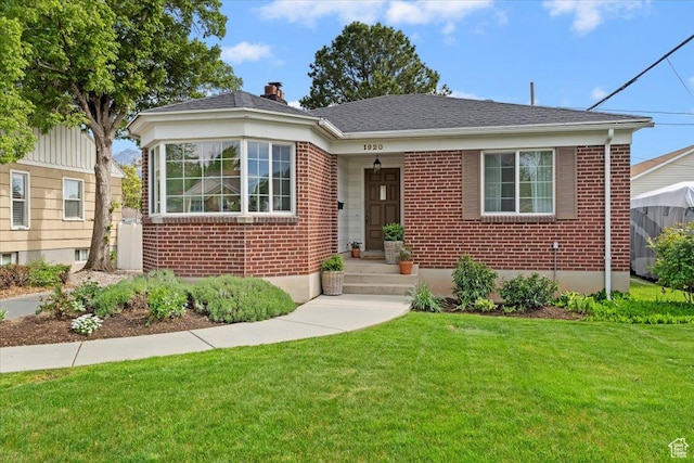 1920 E Westminster Ave, Salt Lake City, UT 84108 - bungalow-style home featuring brick siding, a front lawn, a chimney, and a shingled roof