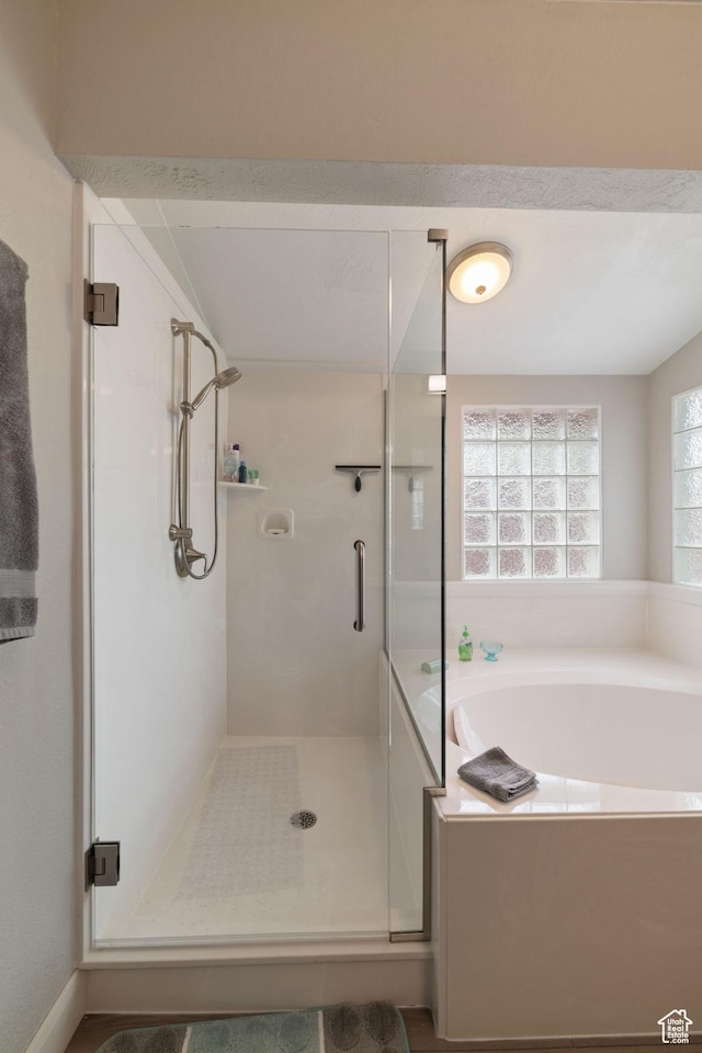full bathroom with a shower stall and a garden tub