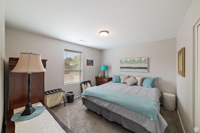 bedroom featuring carpet floors and baseboards